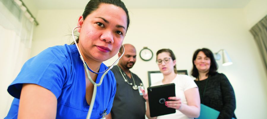 interprofessional health care team at patient bedside